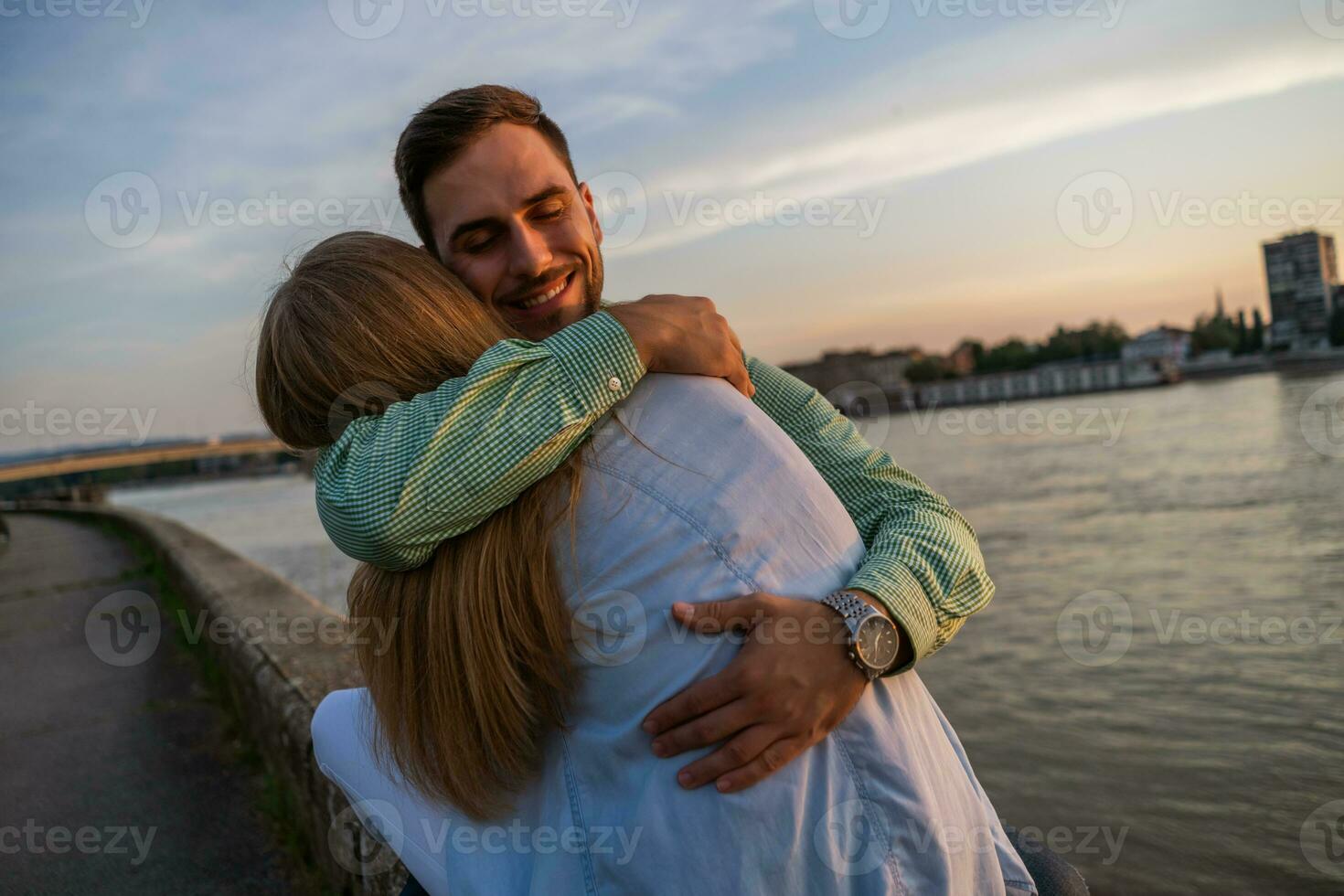 A young couple over the sunset photo