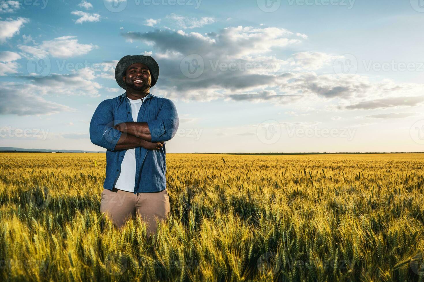 Afro farmer standing in a wheat field photo