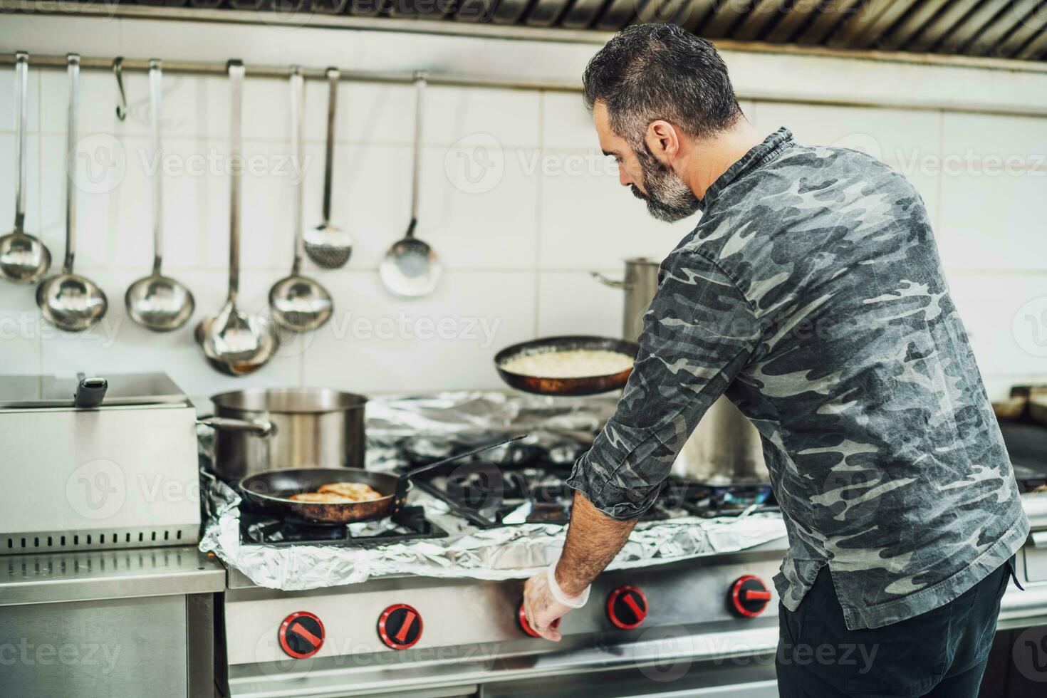 A chef is preparing a meal in the restaurant's kitchen. photo