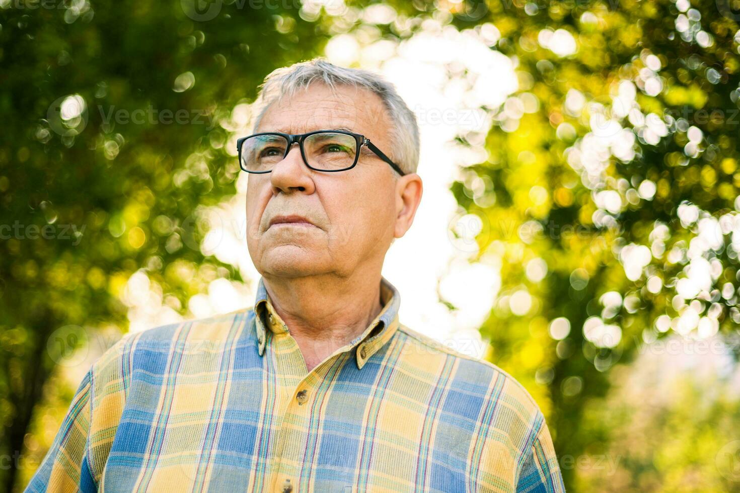 Serious senior man outdoors photo