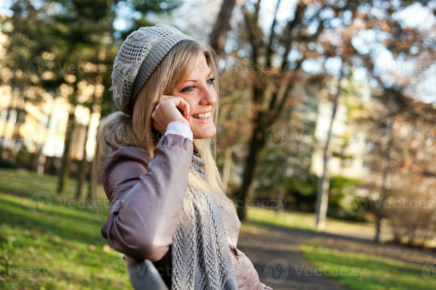 A woman in the park on the phone photo