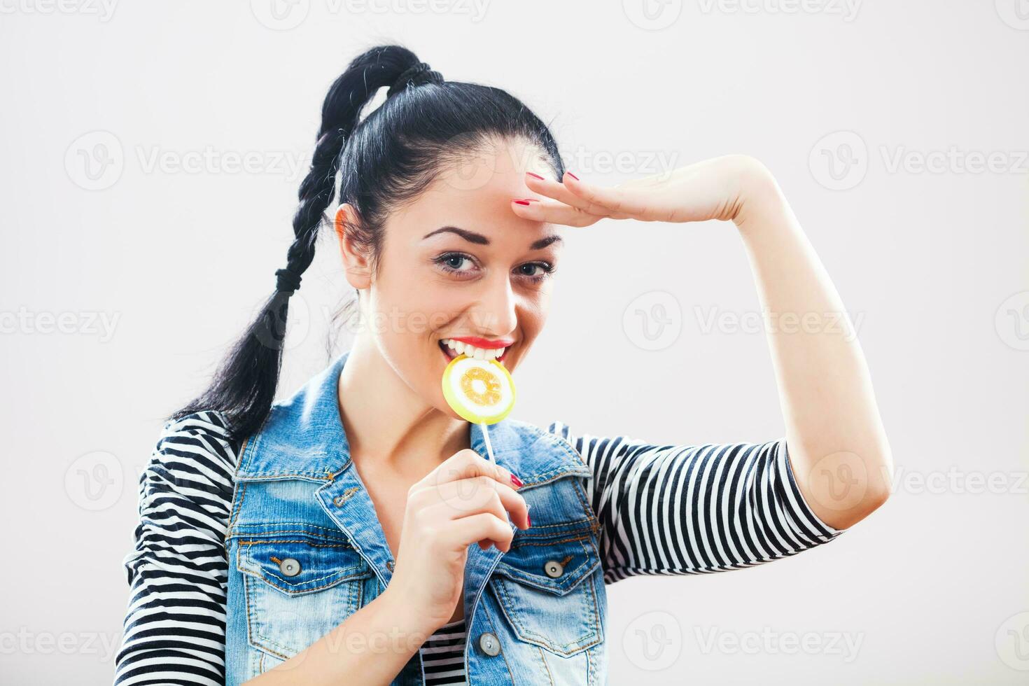 A woman eating a lollipop photo