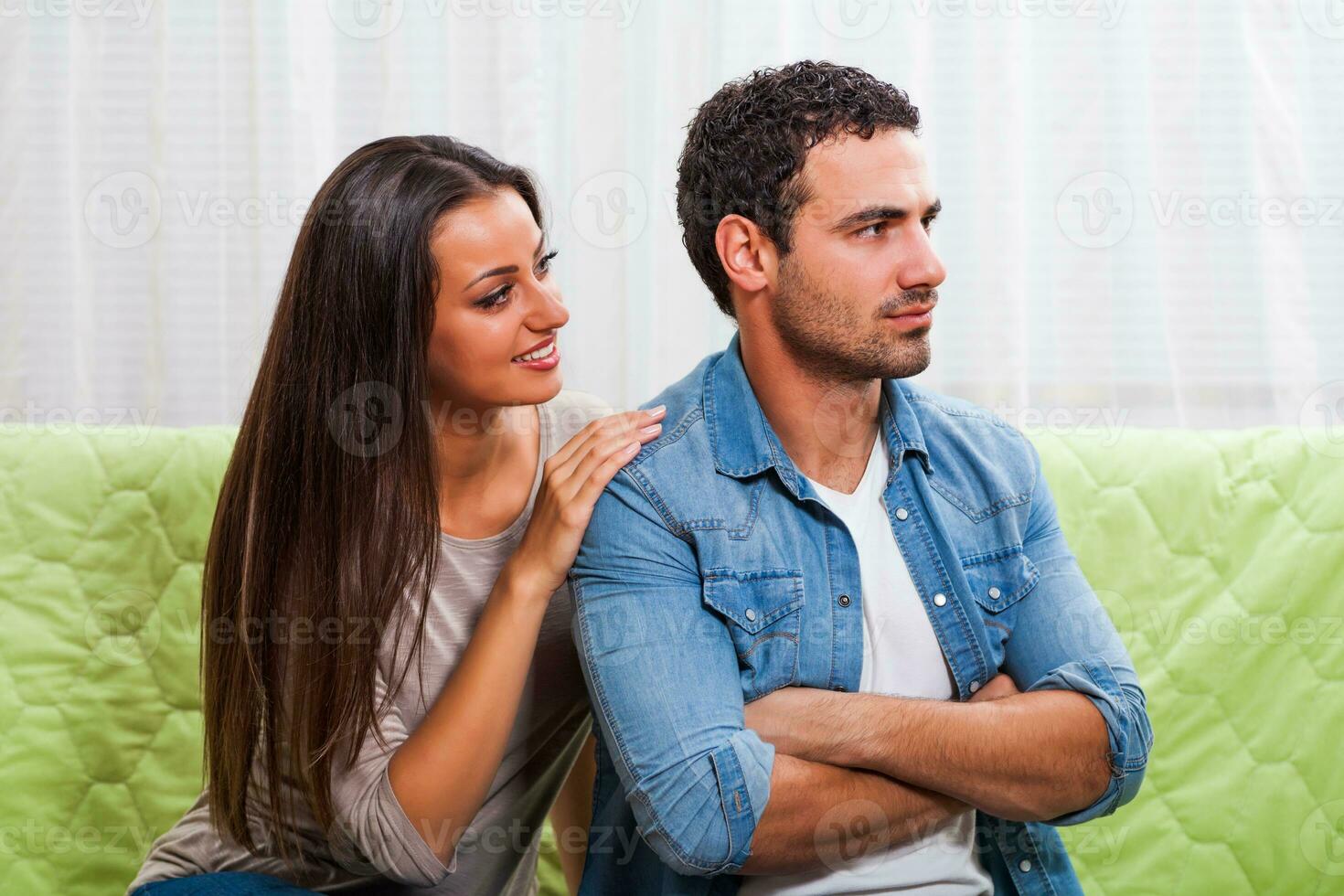 Portrait of a young couple arguing photo
