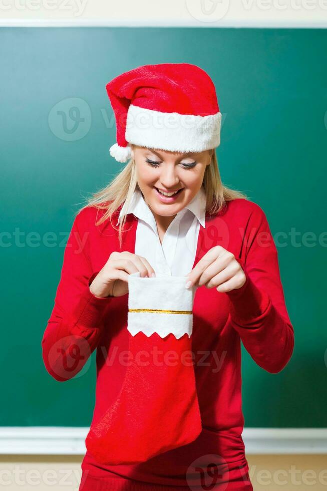 A woman opening her Christmas gift photo