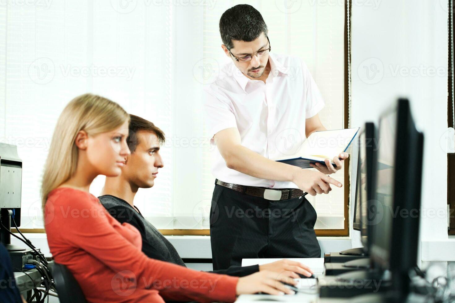 Students learning in a computer lab photo