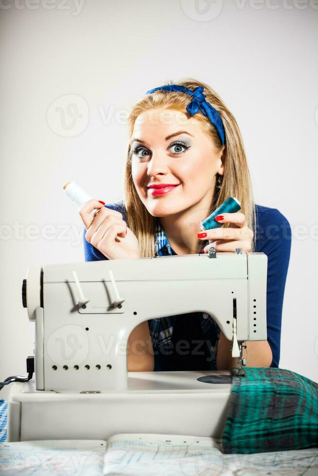 A woman with a sewing machine photo