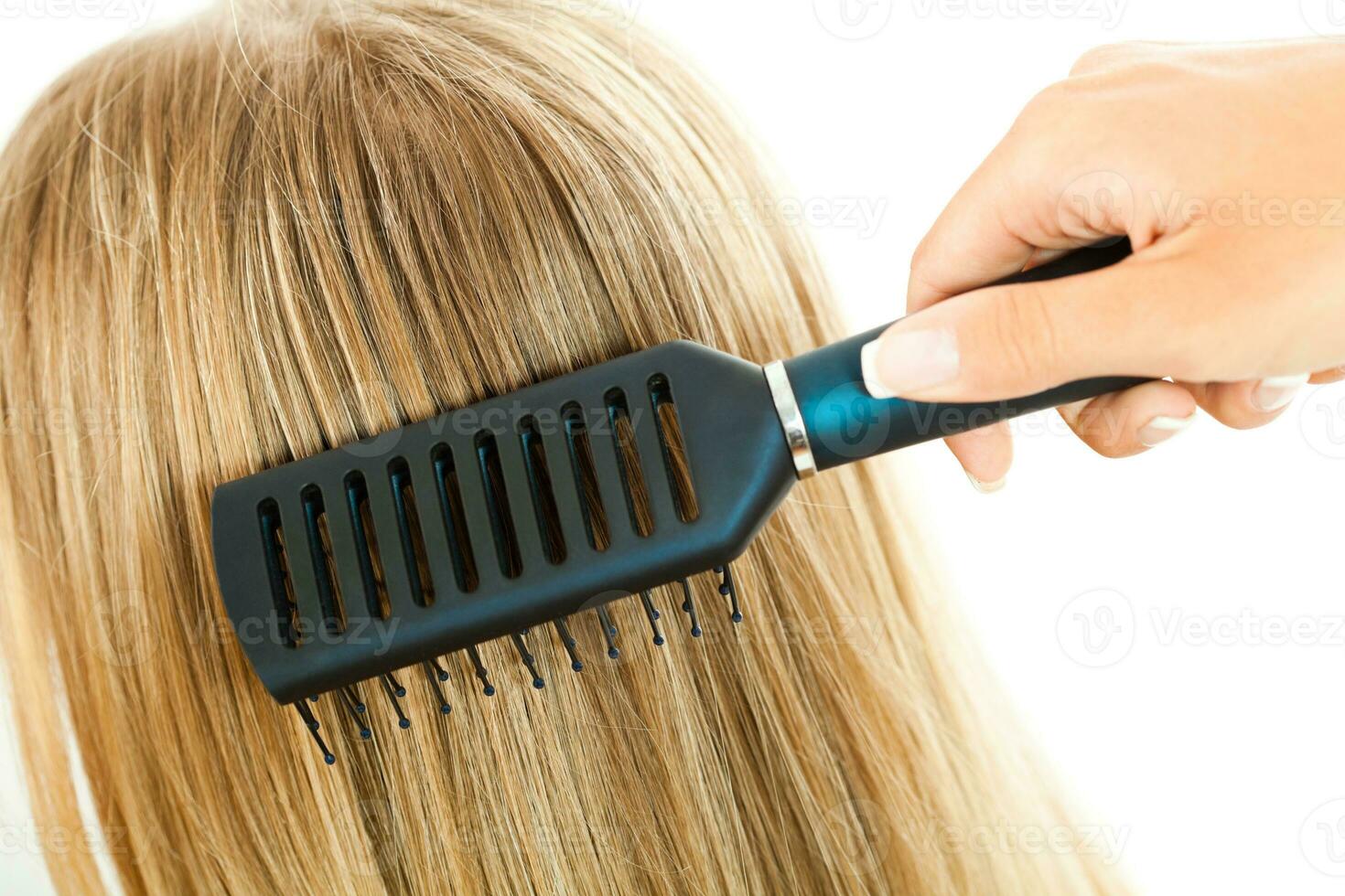 A woman taking care of her hair photo