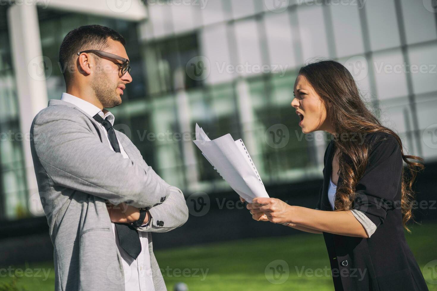 Business colleagues are arguing outside the company building. photo