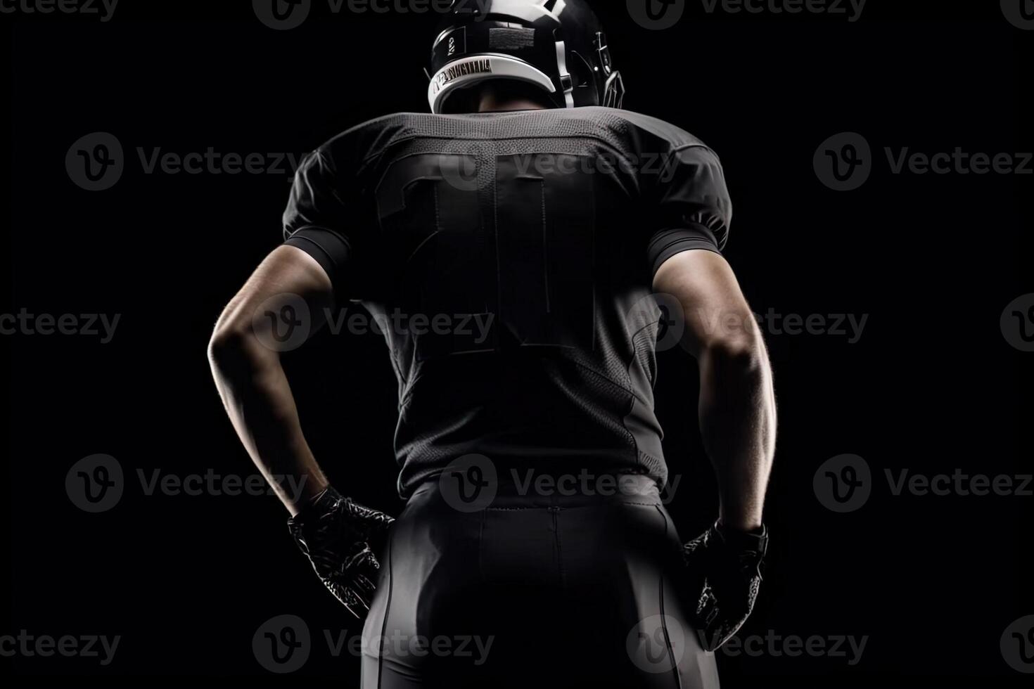 View from the back of american football player isolated on black