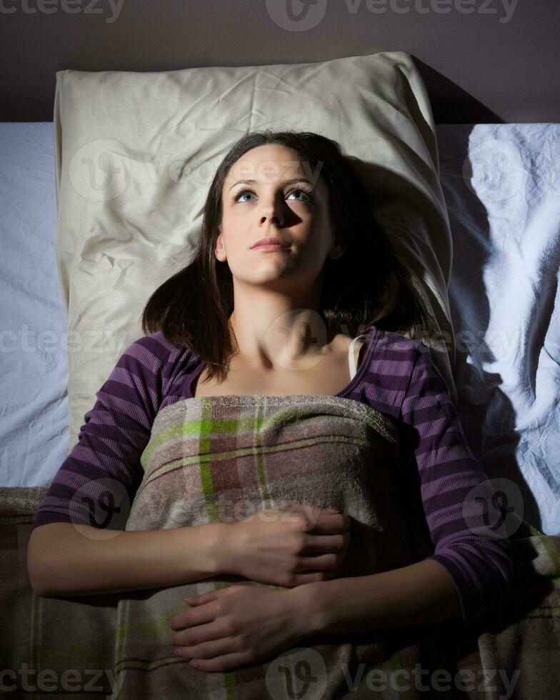 A young woman resting in the bed photo