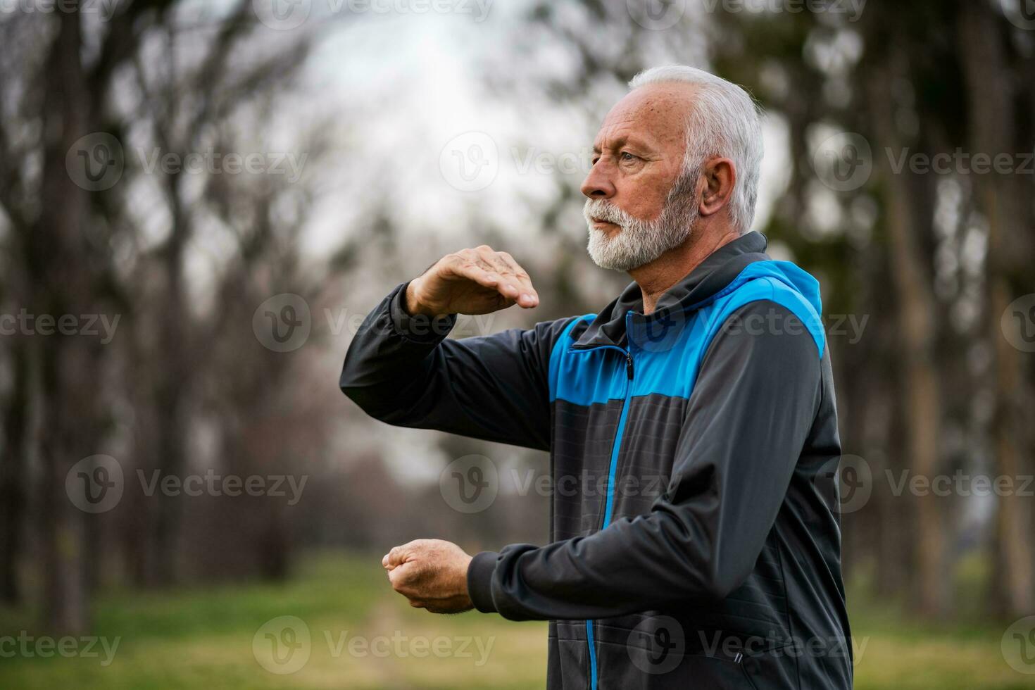 A senior man doing physical exercises photo