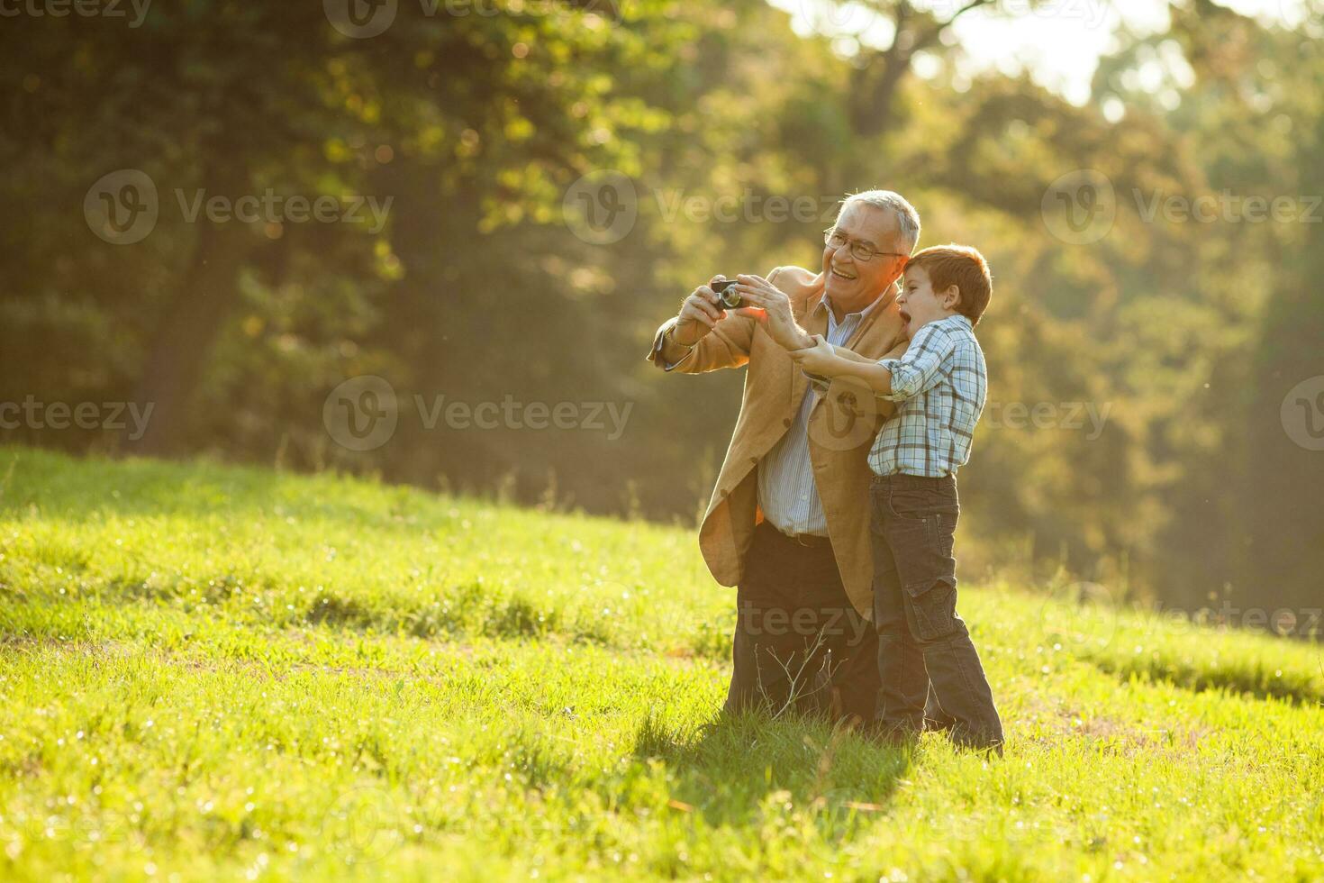 A grandfather and his grandson spending time together outdoors photo