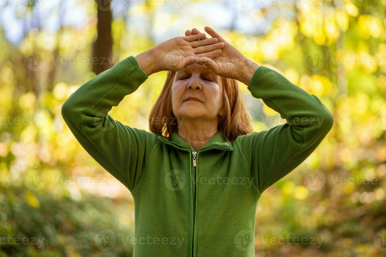 A senior woman doing physical exercises photo