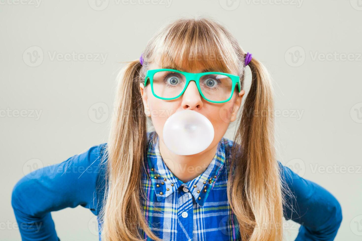 Portrait of a woman with green glasses and bubble gum photo