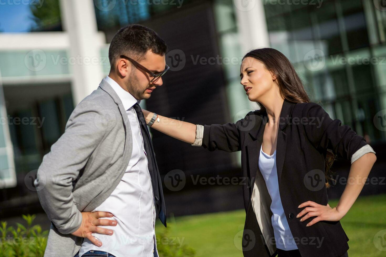 Business colleagues are talking outside the company building. photo