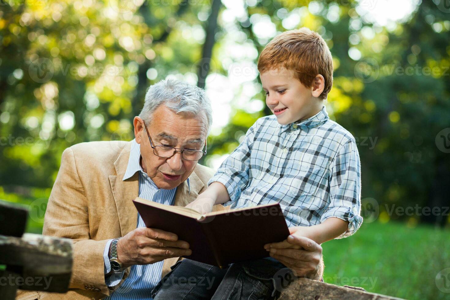 A grandfather and his grandson spending time together outdoors photo