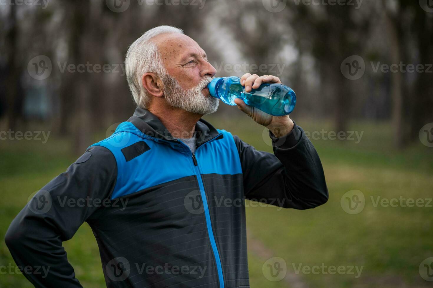 A senior man doing physical exercises photo