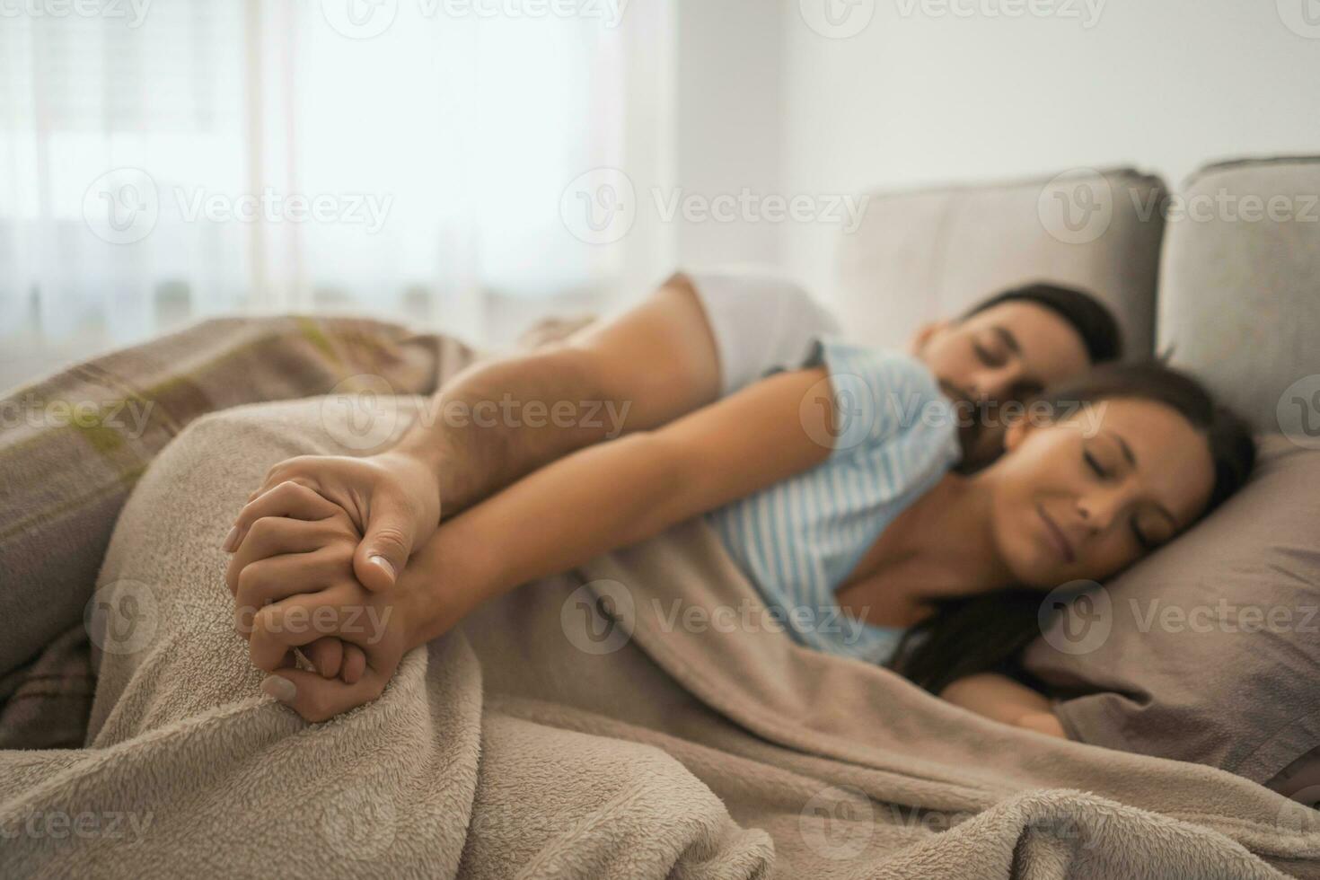 A young couple lying in bed photo