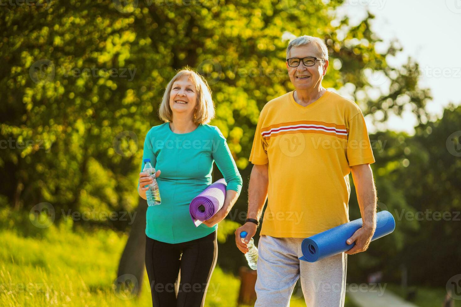Senior couple exercising outdoors photo