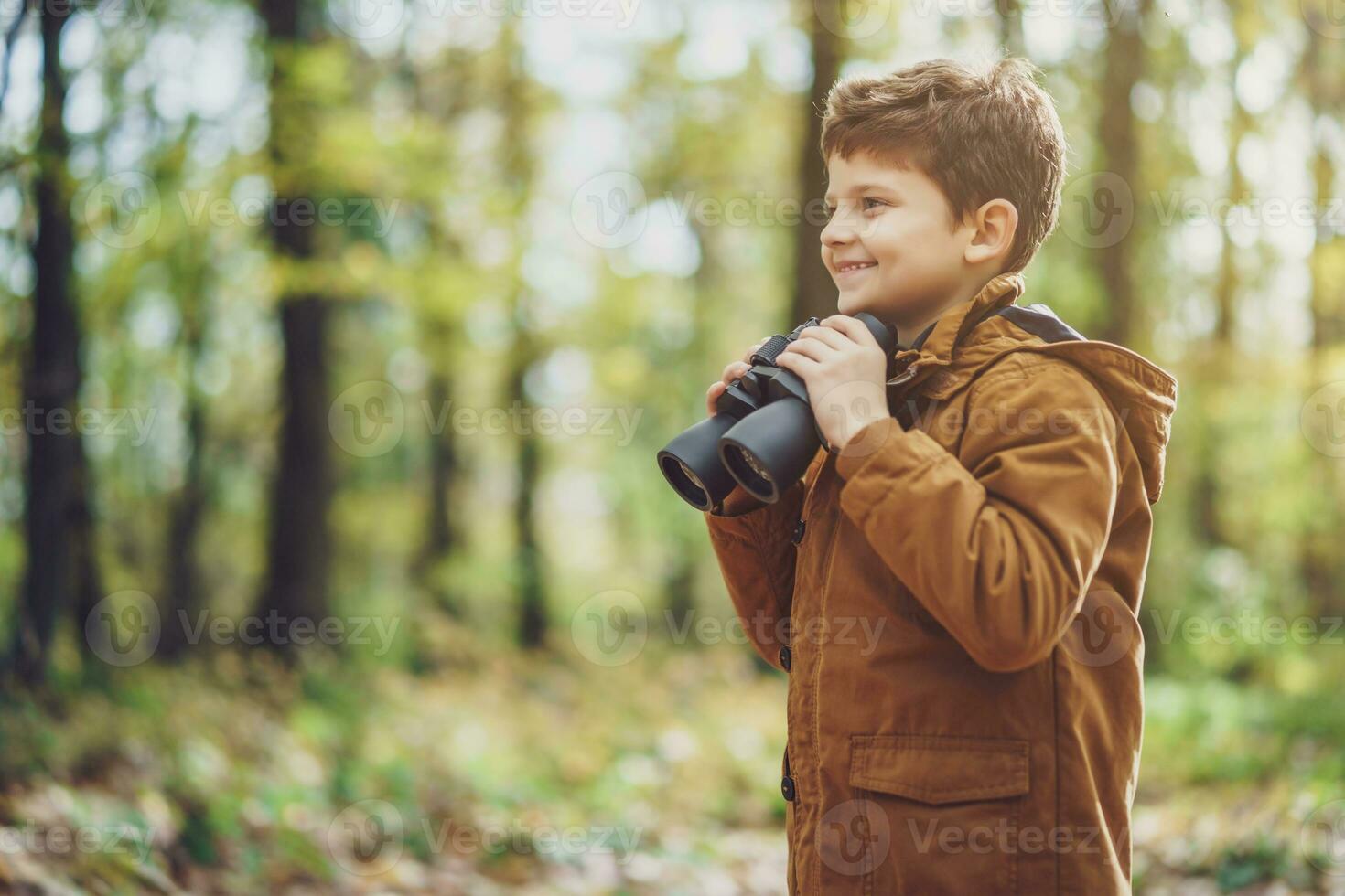 Young boy with binoculars photo