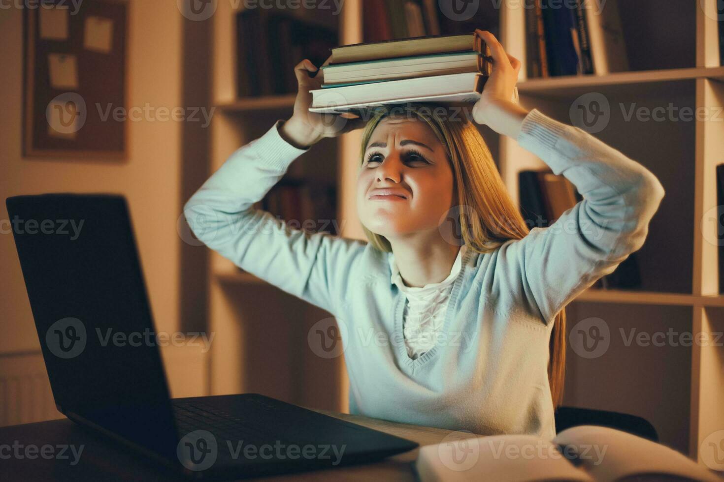 Tired college girl studying late night at home photo