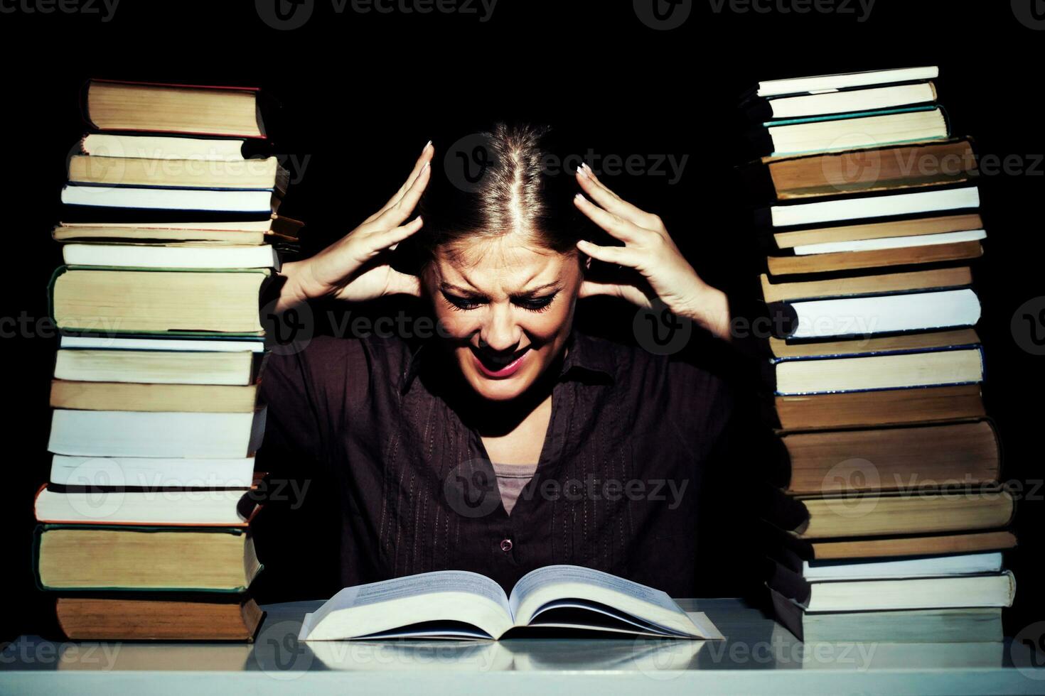 Portrait of a stressed woman with books photo