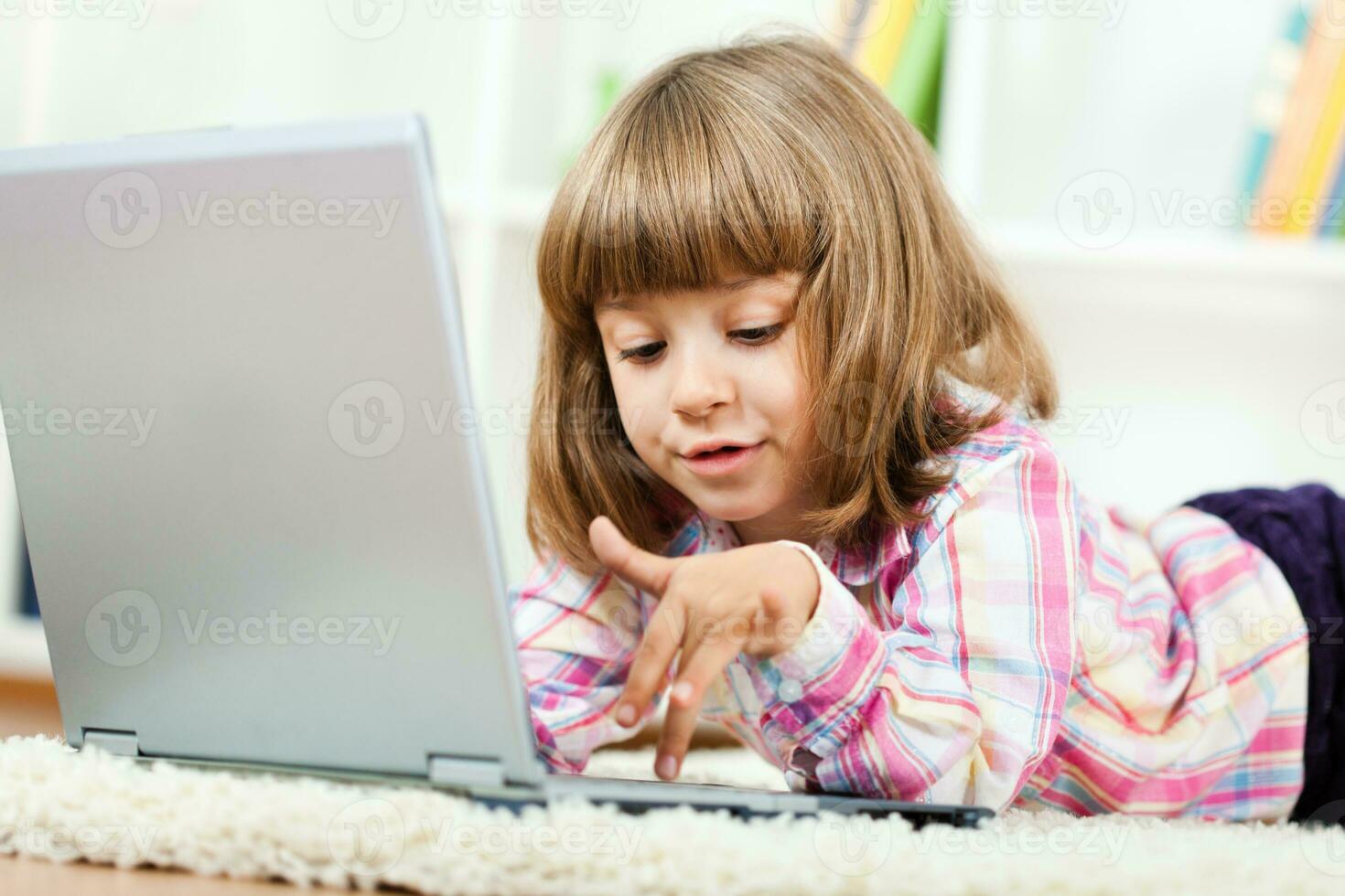 A girl using a laptop photo