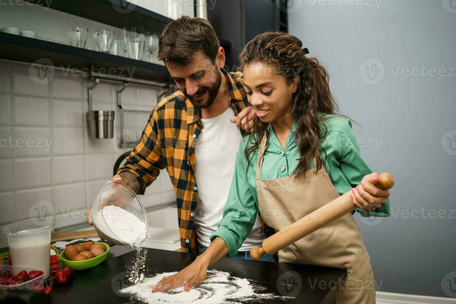 Happy multiethnic couple cooking together photo