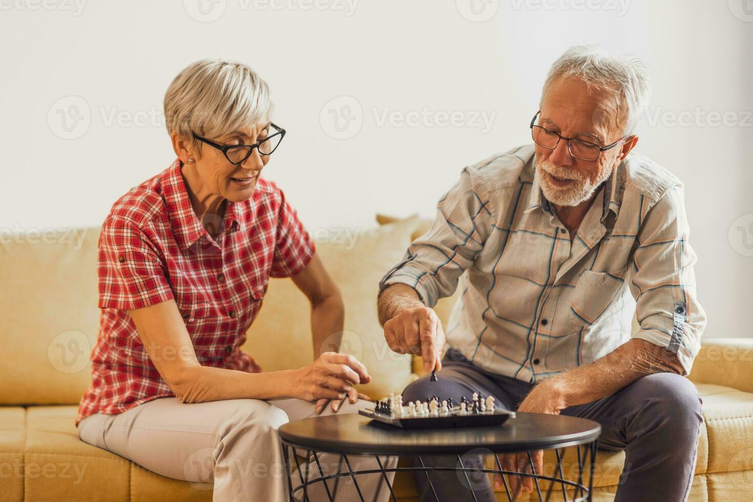 A senior couple playing chess. photo