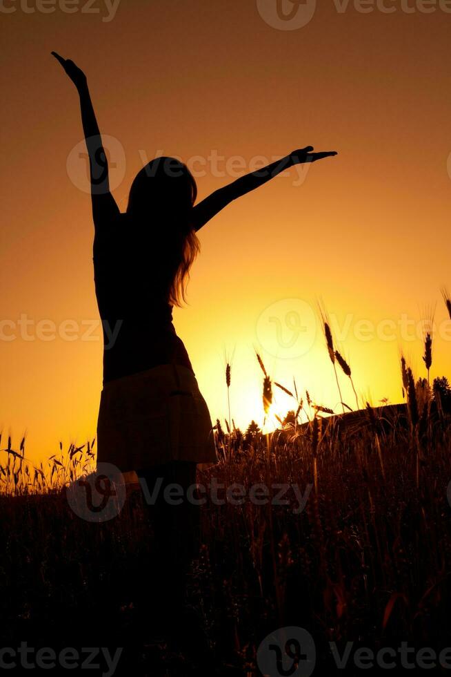 Silhouette of a woman at sunset photo