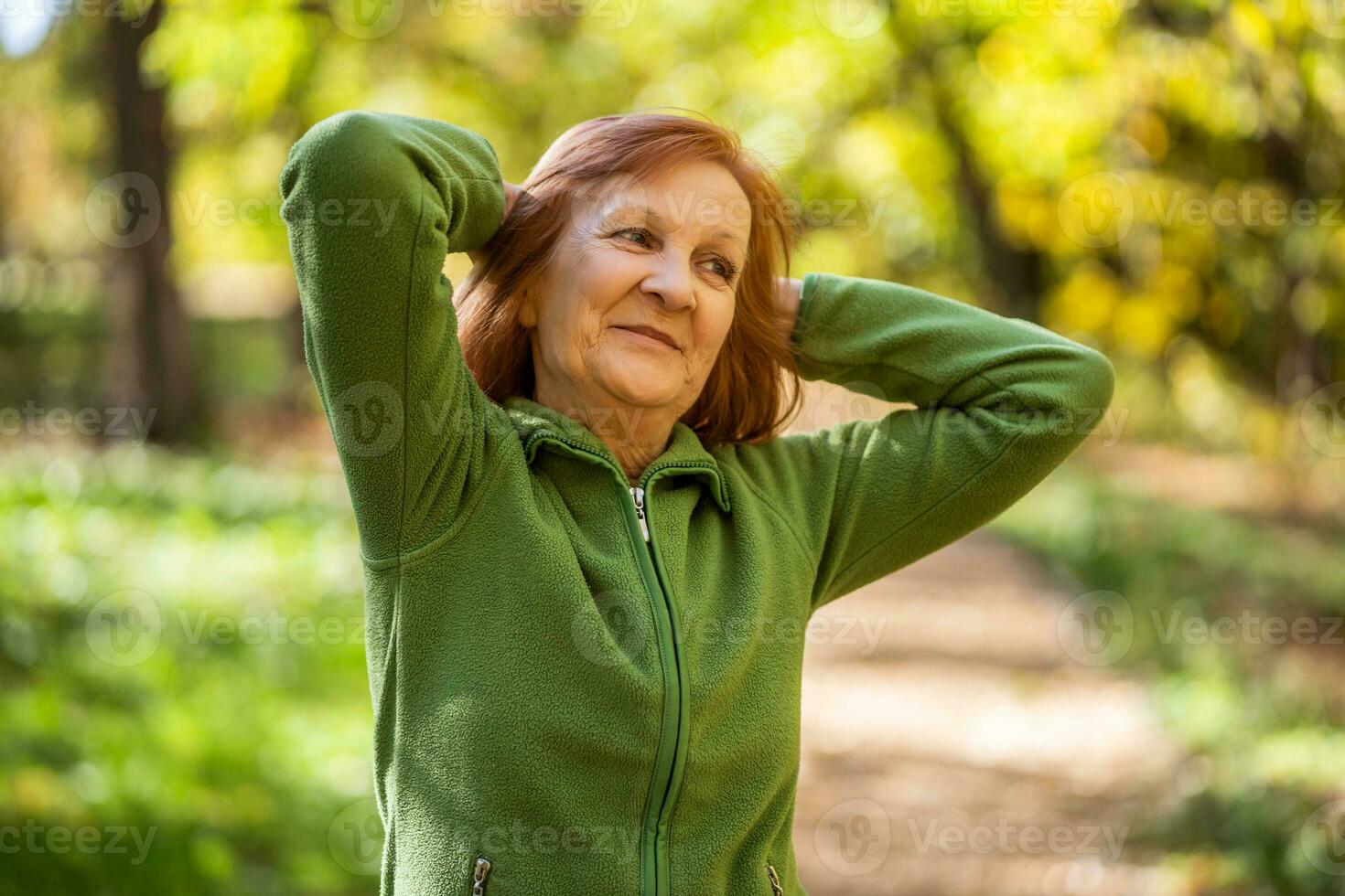 A senior woman doing physical exercises photo