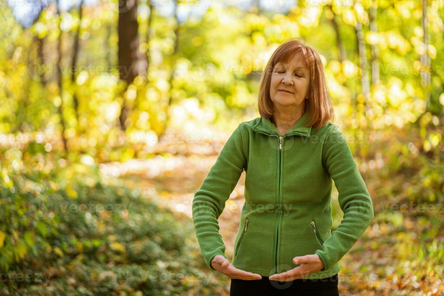 A senior woman doing physical exercises photo