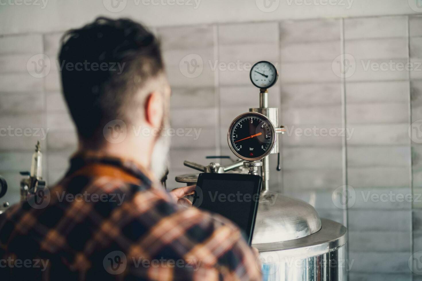 A brewery master supervising the beer production process photo