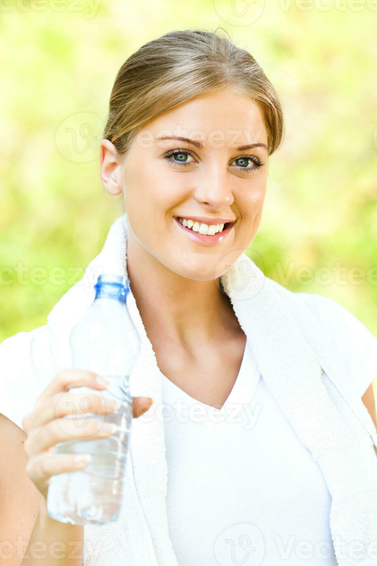 Woman drinking water after doing physical activity 23949926 Stock Photo