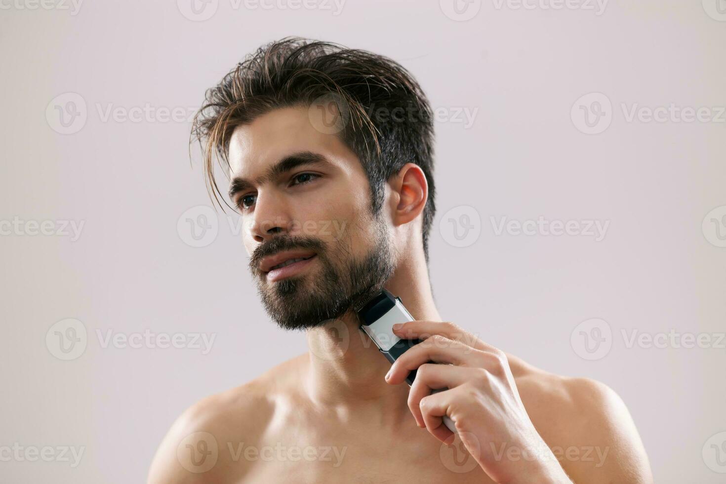 A man grooming his beard photo