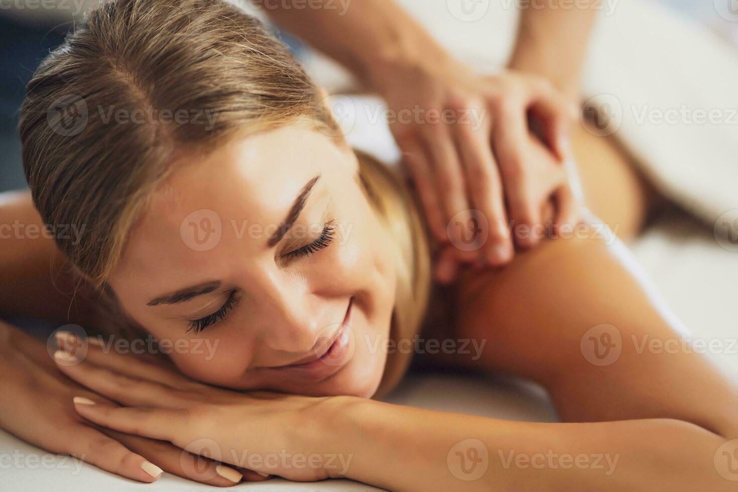 Woman enjoying a back massage photo
