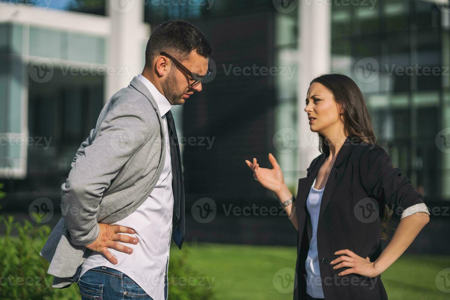 Business colleagues are arguing outside the company building. photo