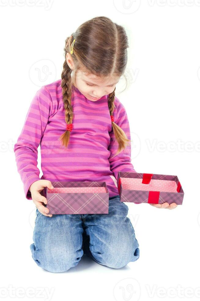 A little girl opening a gift photo