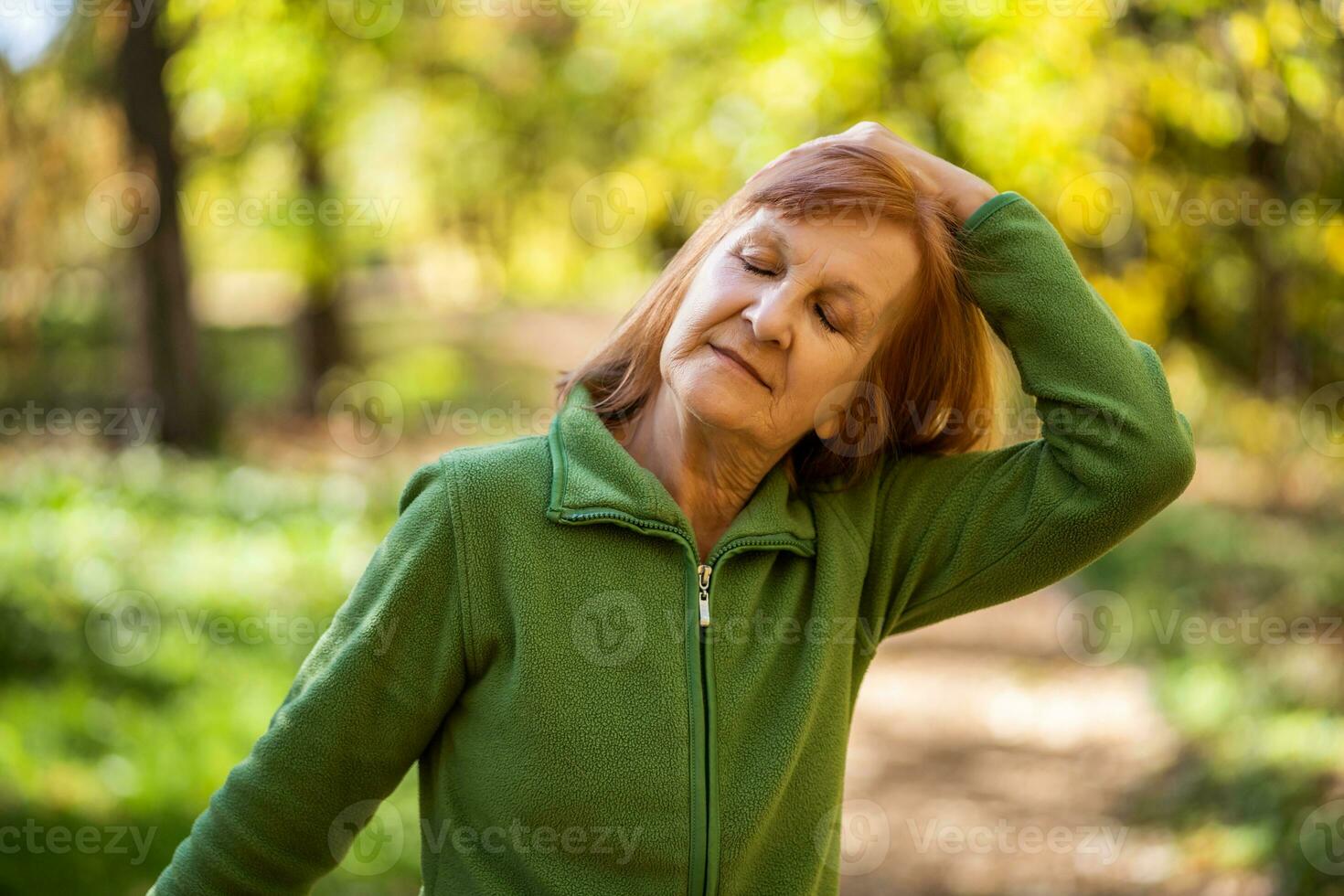 A senior woman doing physical exercises photo
