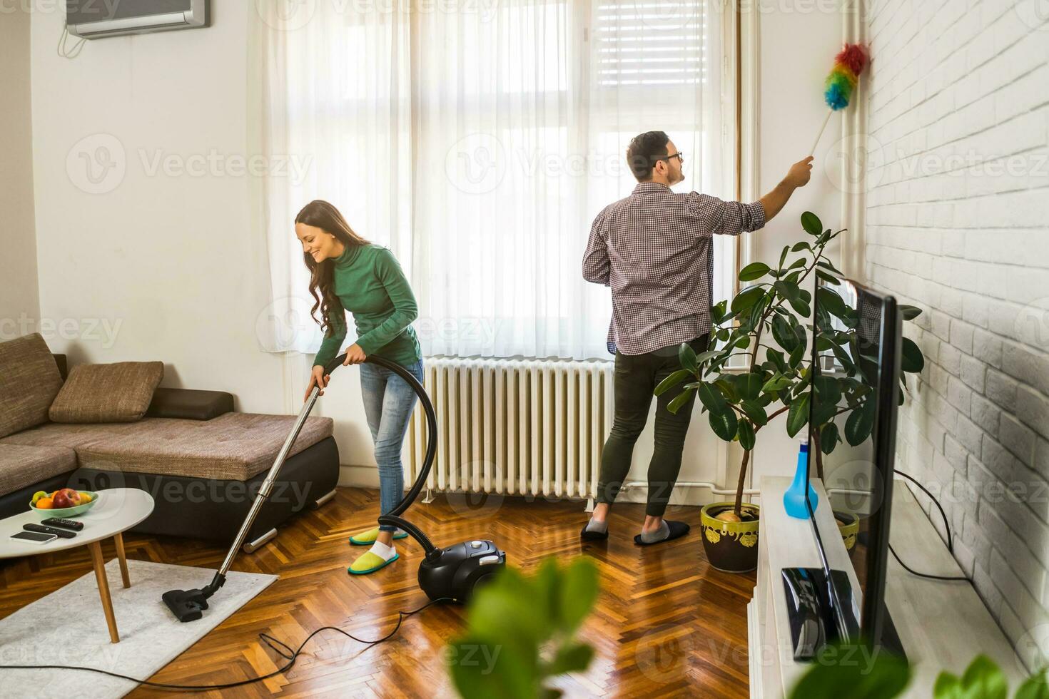 Young couple is cleaning their apartment photo