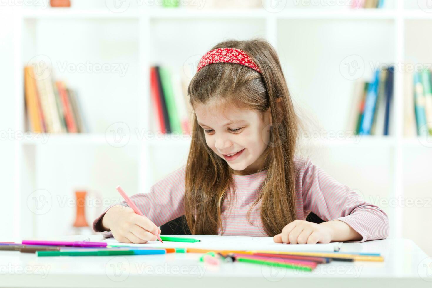 A little girl drawing photo