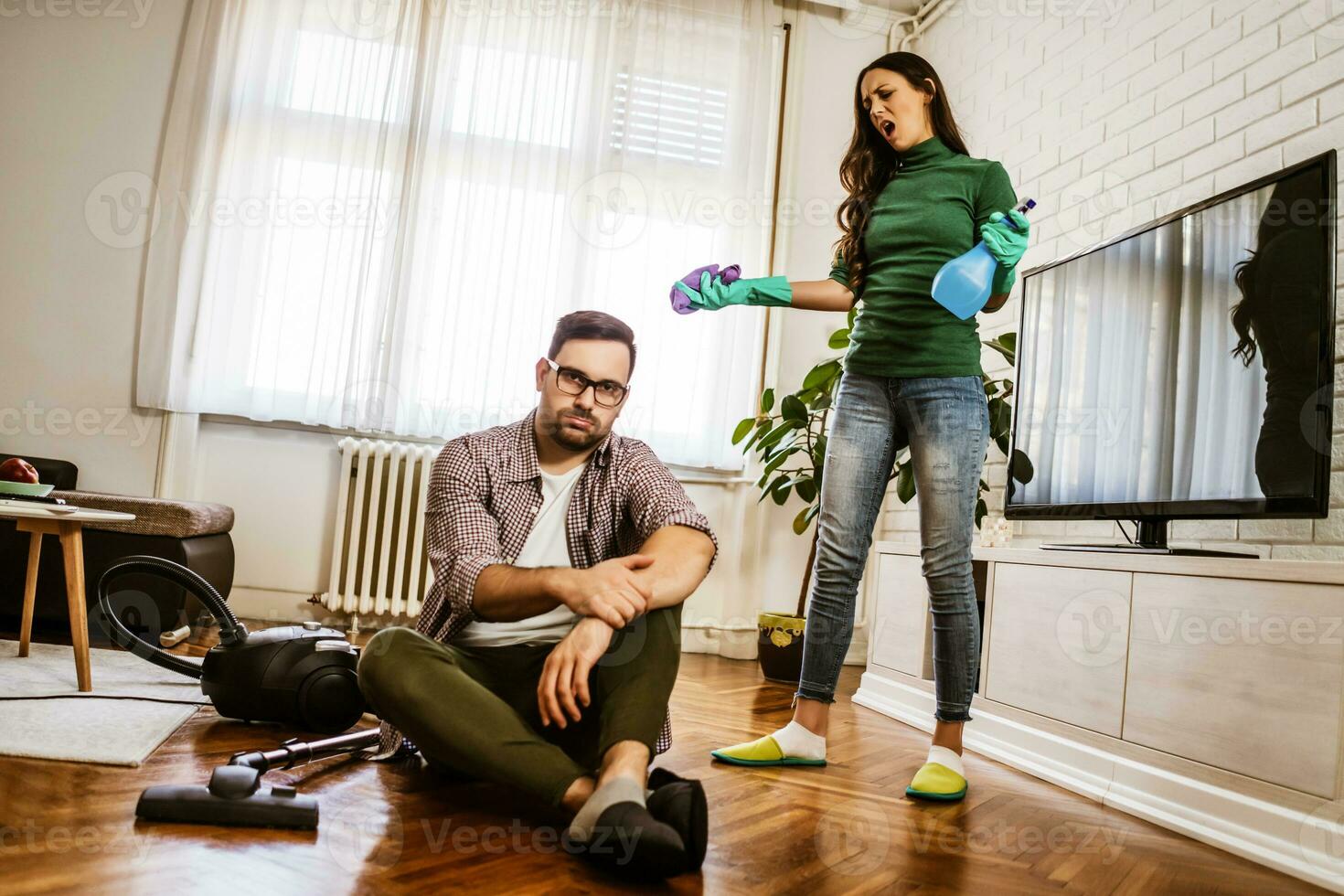 Young couple is cleaning their apartment photo