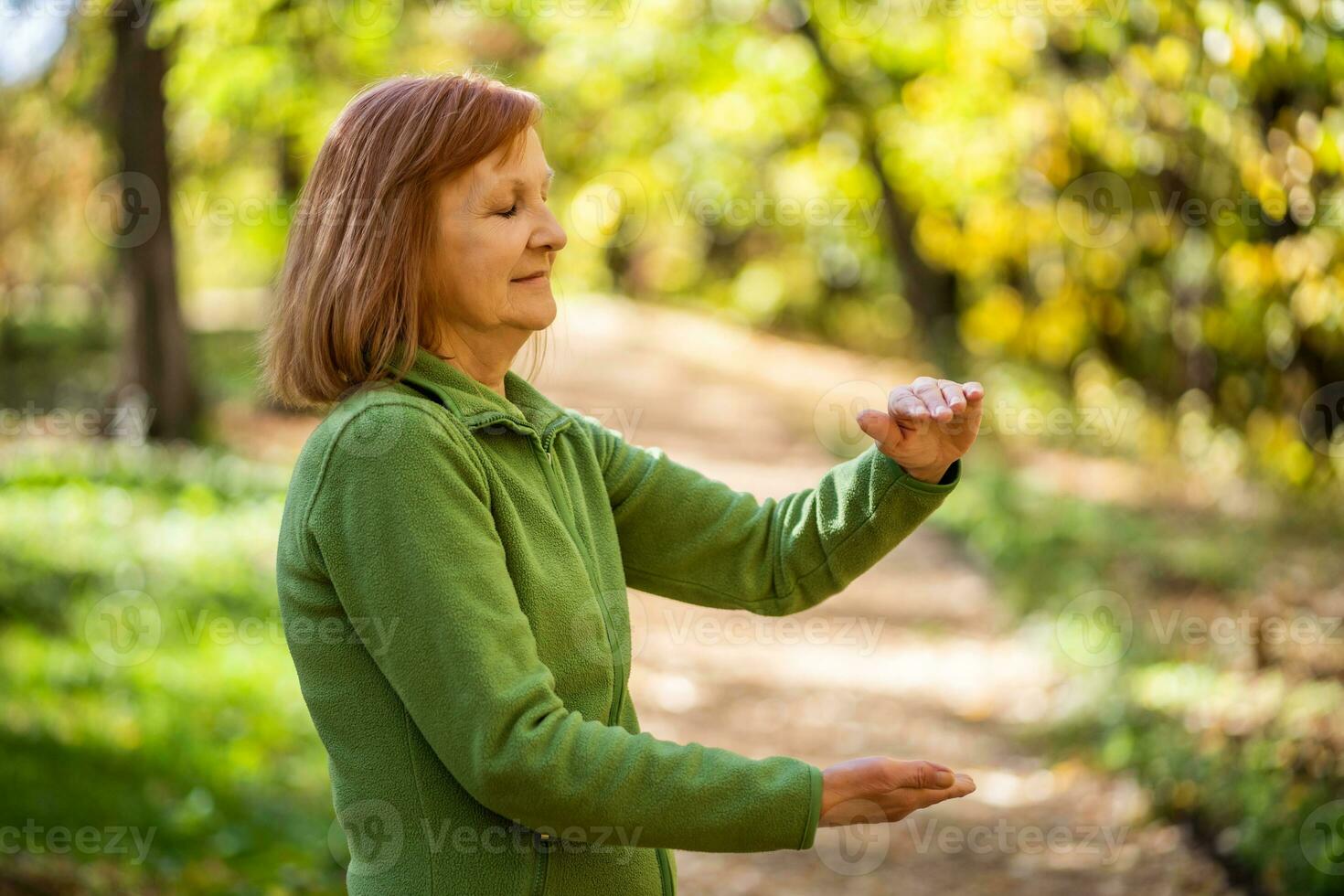 A senior woman doing physical exercises photo