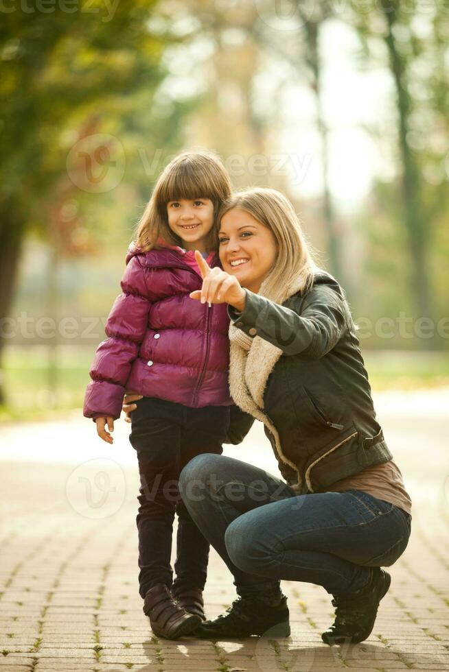 A mother with her daughter in the park photo