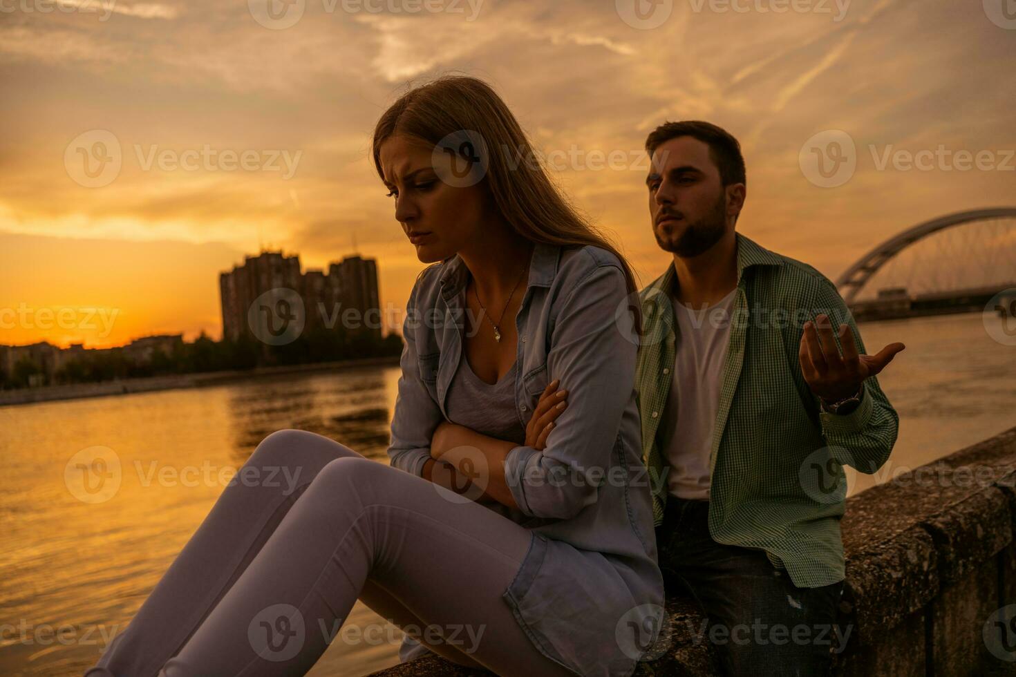 A young couple over the sunset photo