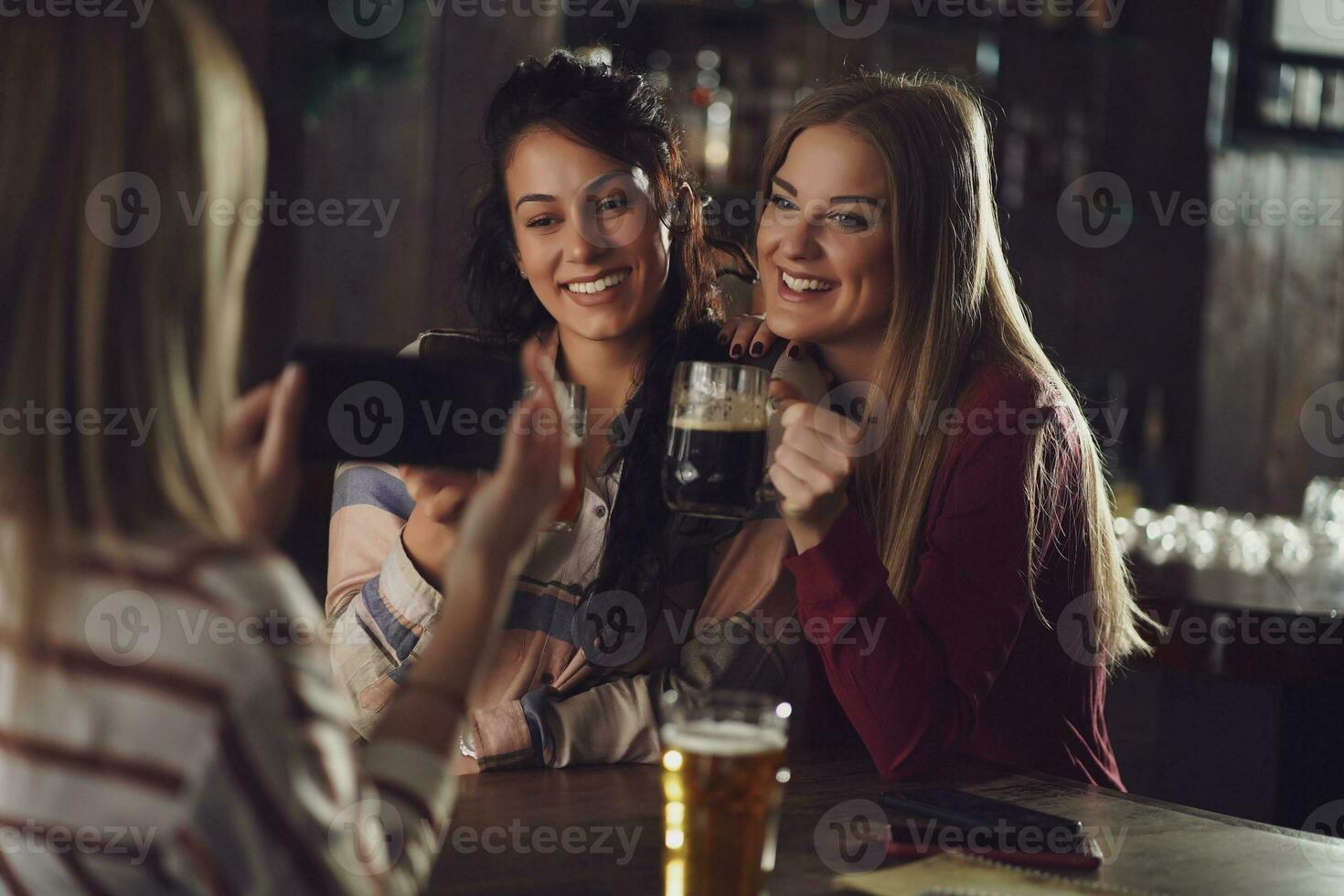 Friends having fun at the bar photo