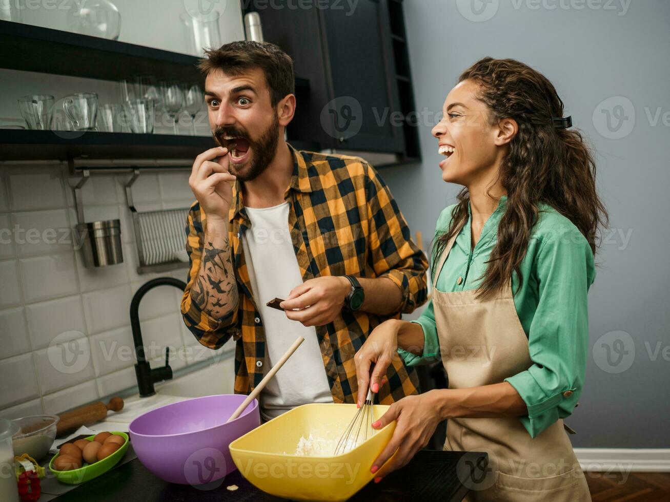 Happy multiethnic couple cooking together photo