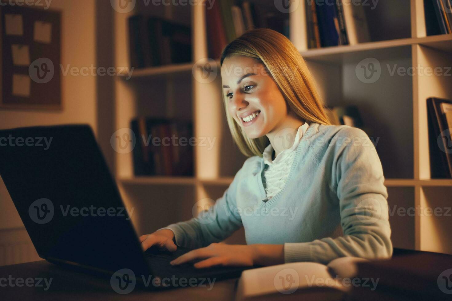Tired college girl studying late night at home photo