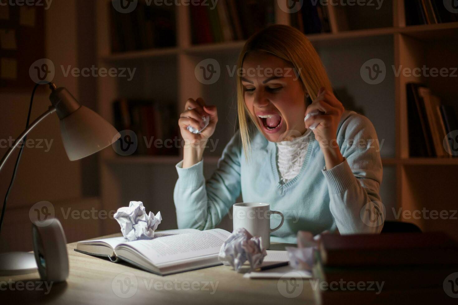 Tired college girl studying late night at home with the flu photo