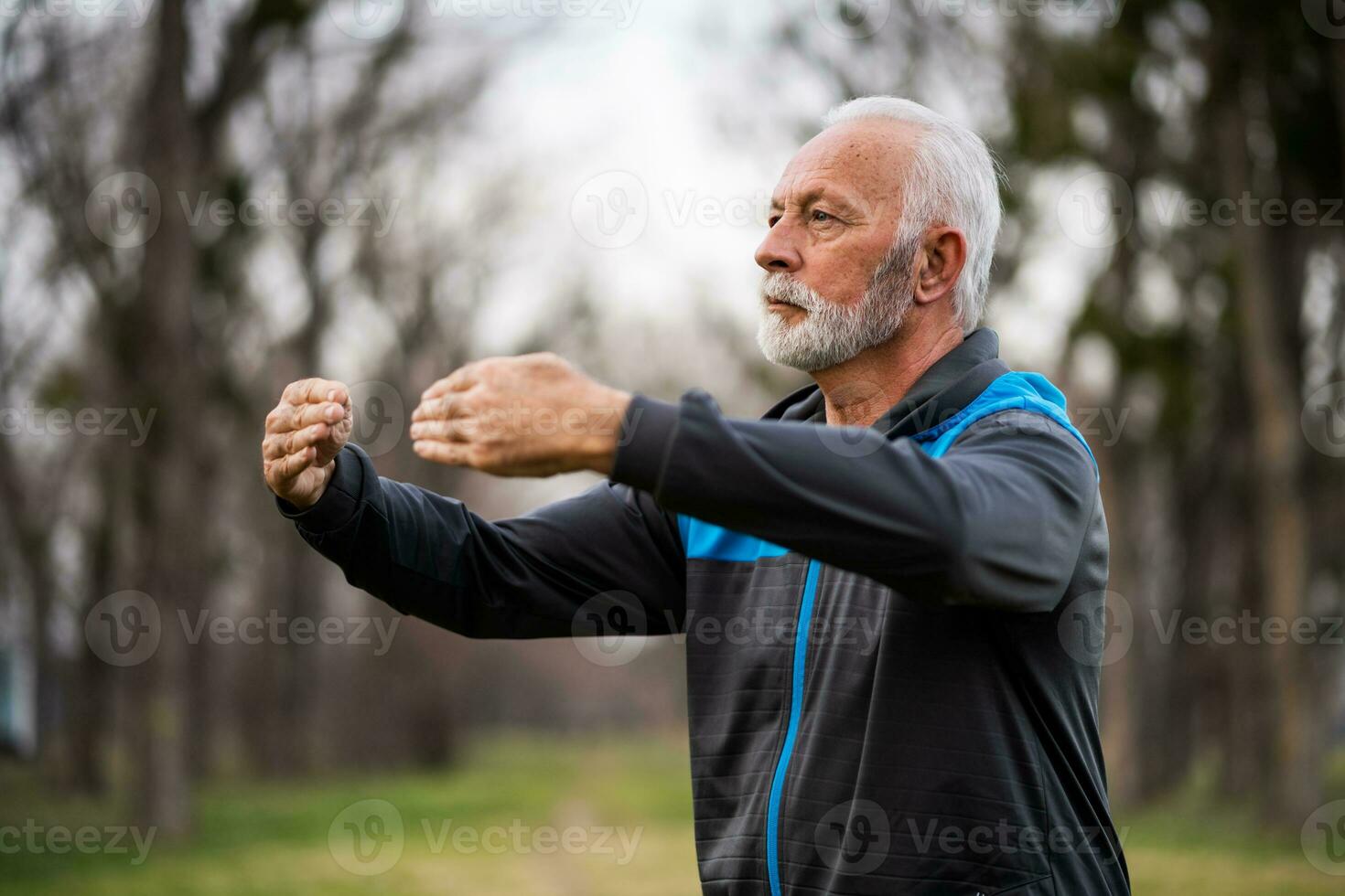 A senior man doing physical exercises photo
